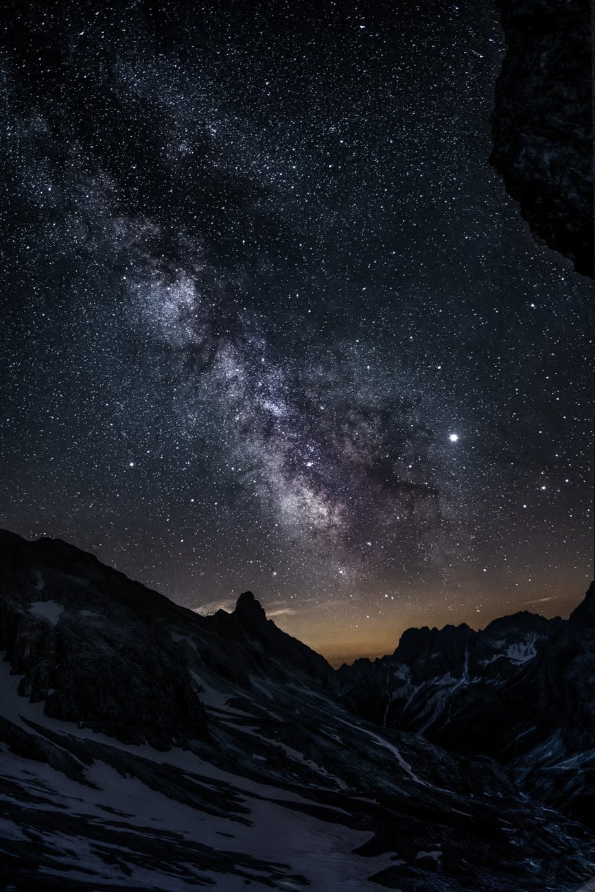 photo of mountain under starry night sky